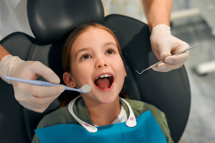 child-little-girl-sitting-dental-chair-opening-her-mouth-wide-examination-by-pediatric-dentist-dental-clinic-dentistry-care-milk-teeth_189498-6044